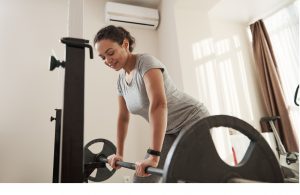 Strong lady using a heavy barbell