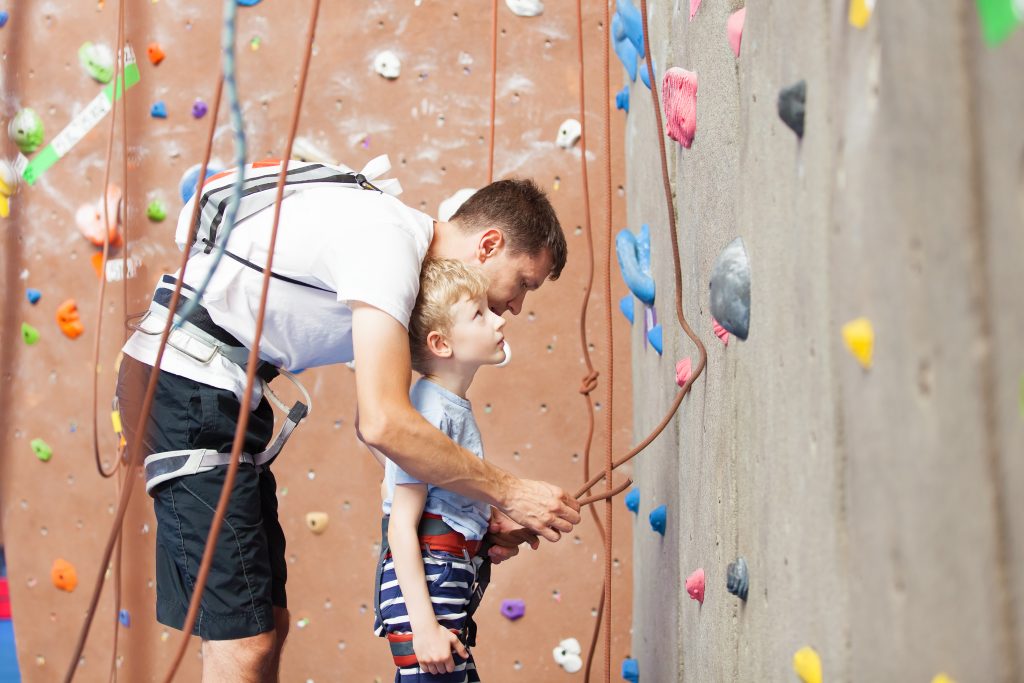 Father and sun rock climbing