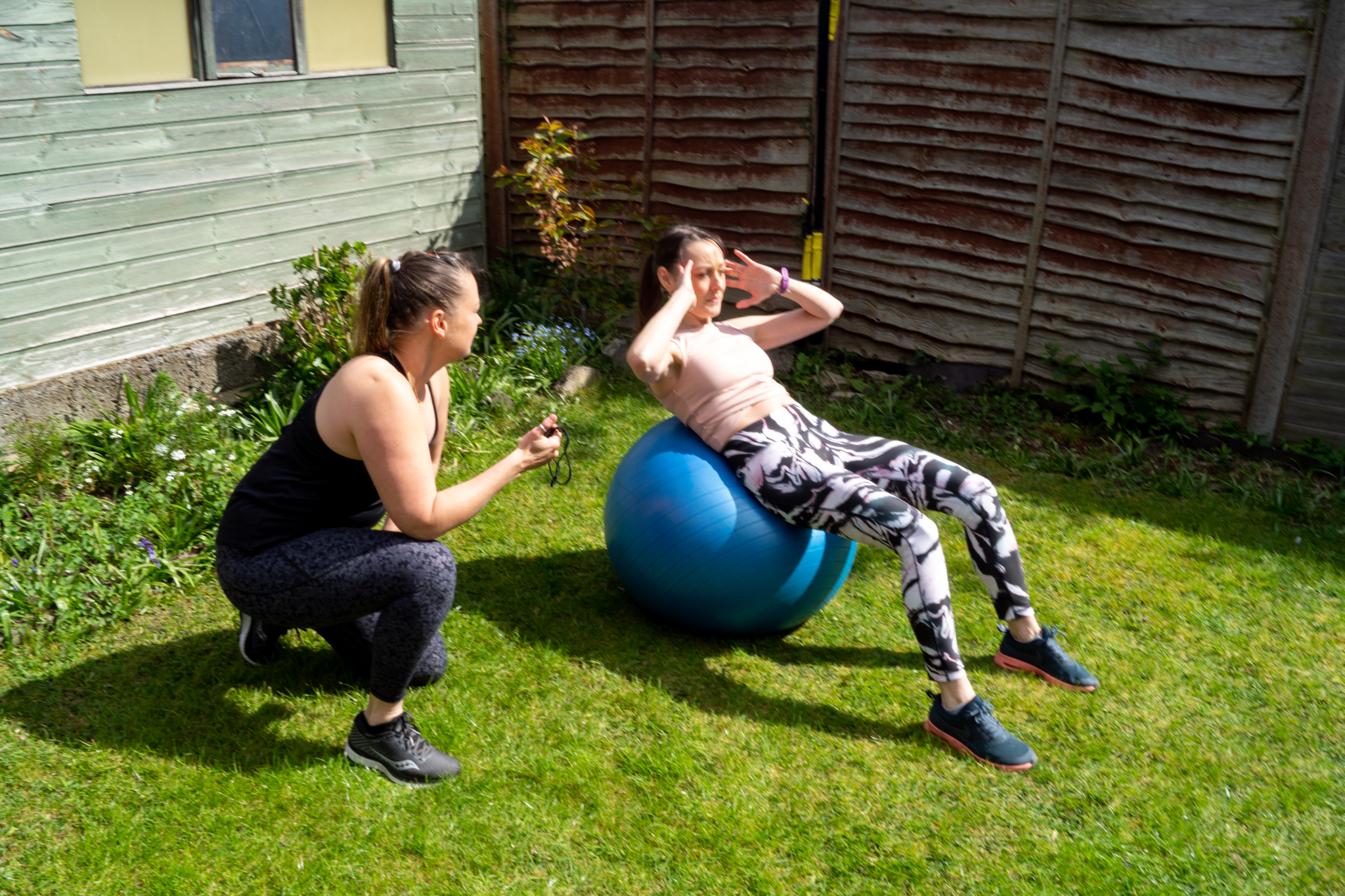 Trainer with client on a swiss ball