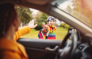 Waving child off to school