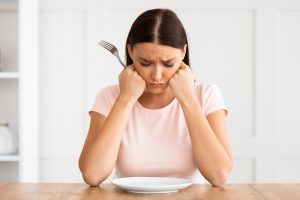 Plate empty and unhappy lady